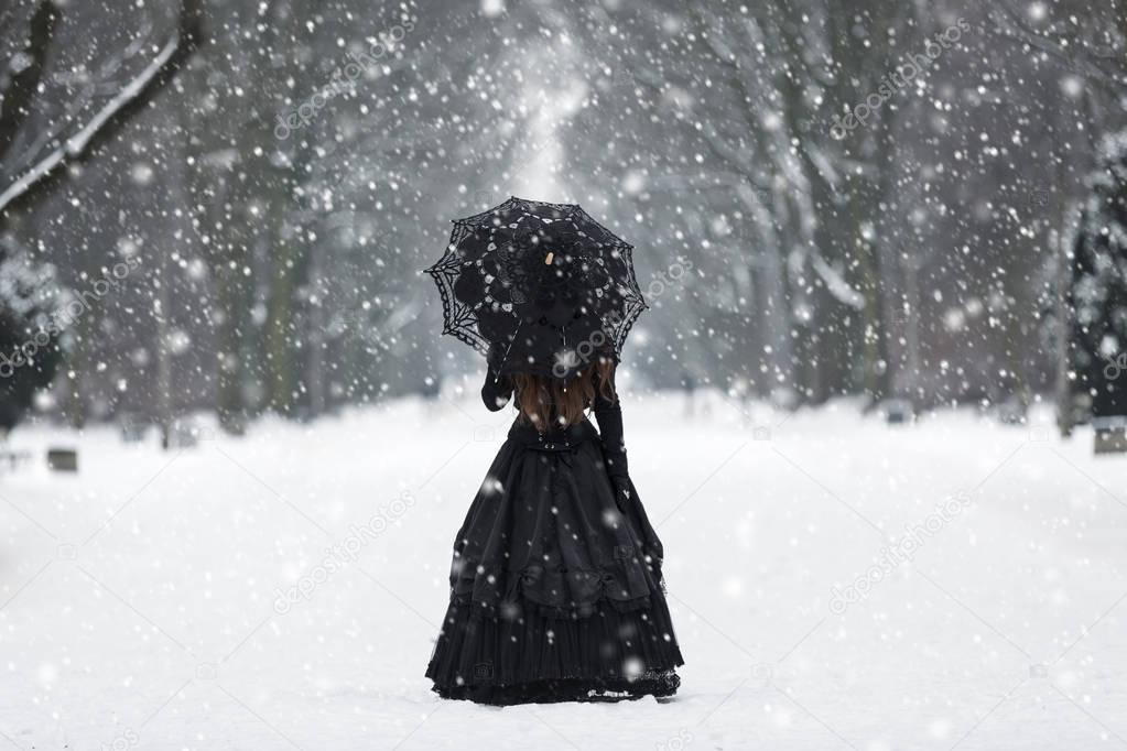 Mysterious lonely woman in Victorian dress 