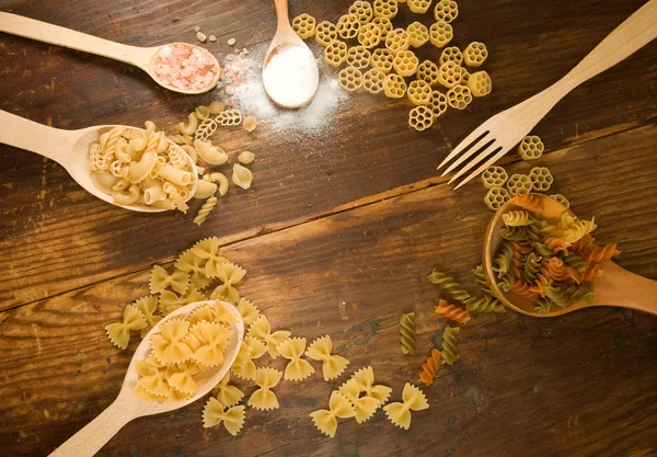 Dry vermicelli, salt and spoons on a wooden table — Stock Photo, Image