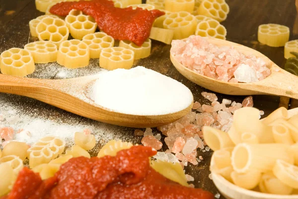 Dry vermicelli, salt and spoons on a wooden table — Stock Photo, Image