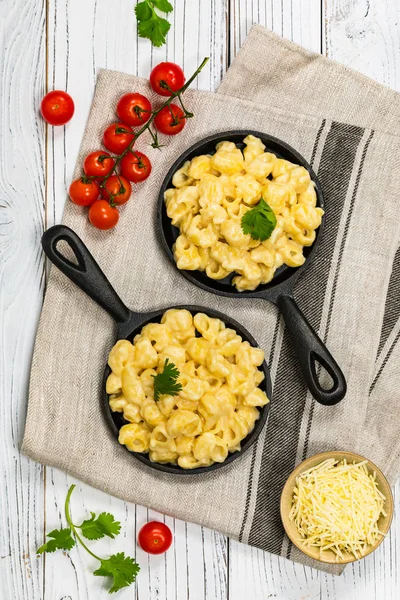 Macaroni and Cheese Old Fashioned Skillet on Wooden Background. Selective focus.