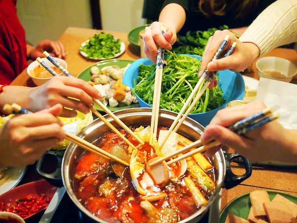 People is cooking with Chinese hotpot with chopsticks. — Stock Photo, Image