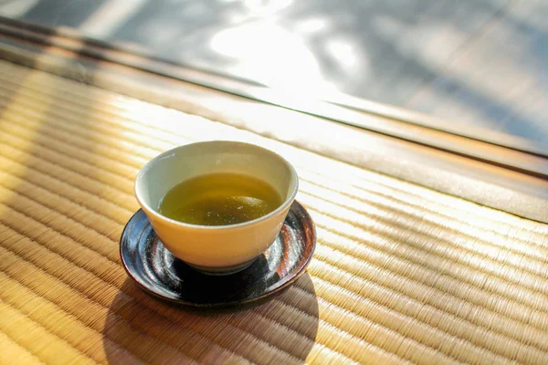 Afternoon tea spa day. A cup of green tea on a traditional Japanese mat, tatami