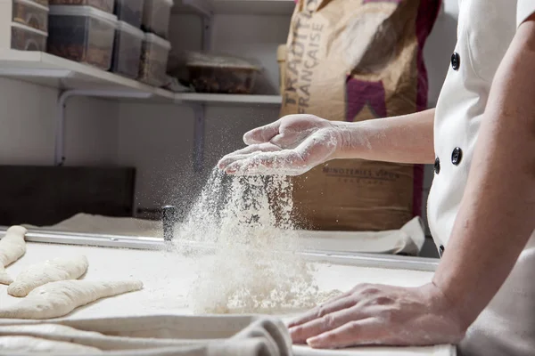 Baker is preparing bread with spelt flour