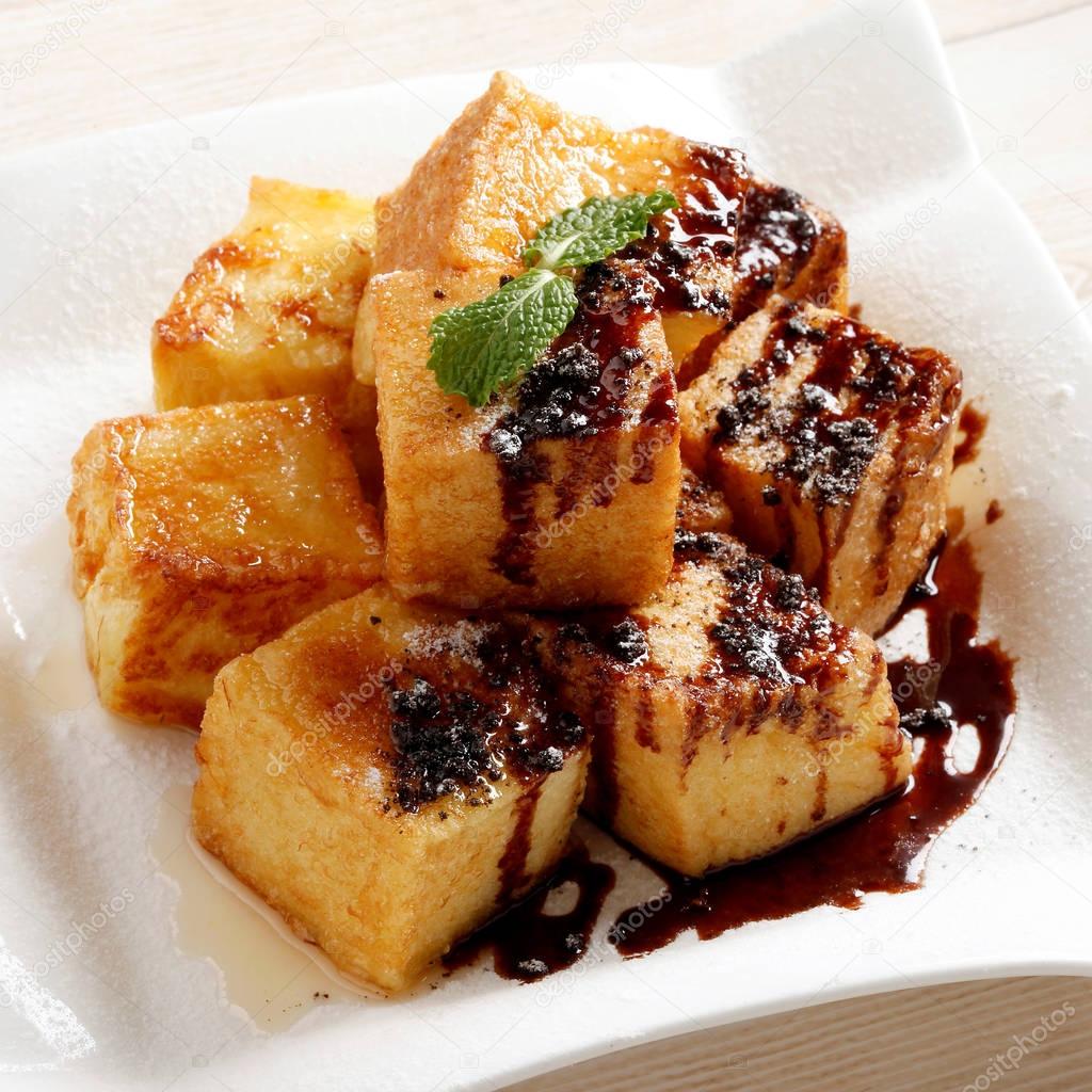 Close up of fried soya bean curd cubes in a white plate