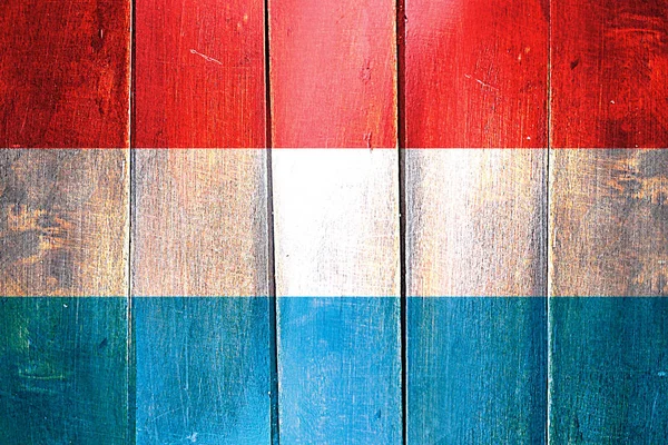 Vintage Luxembourg  flag on grunge wooden panel — Stock Photo, Image