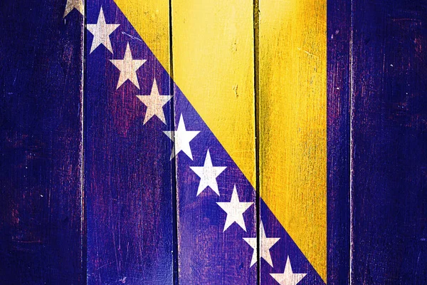 Vintage Bosnia and Herzegovina  flag on grunge wooden panel — Stock Photo, Image