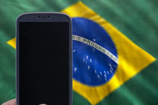 Holding smartphone with brazilian flag Stock Photo