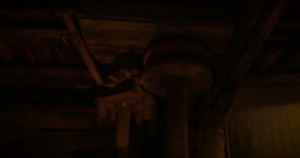 Ancient wooden mill machinery illuminated by candlelight — Stock Video