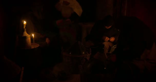 Weavers of wicker baskets illuminated by candlelight — Stock Video