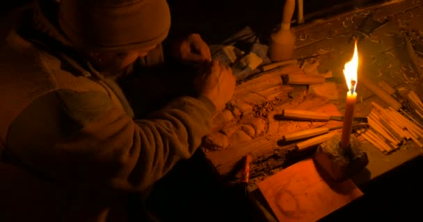 A wood carver illuminated by candlelight — Stock Video