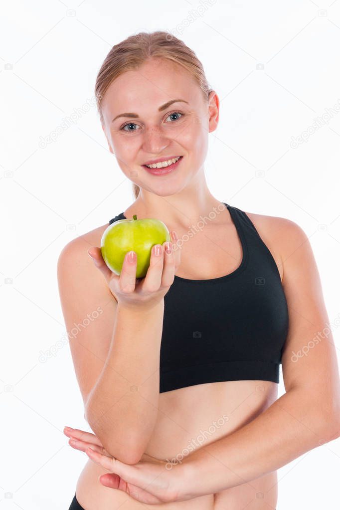 Coquettish girl with a green apple in her hand