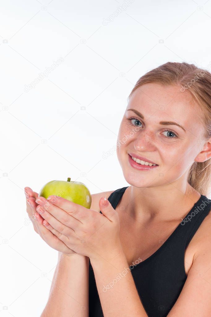 Coquettish girl with a green apple in her hand