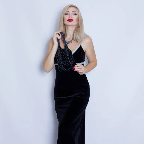 Young beautiful blonde woman in black evening dress — Stock Photo, Image