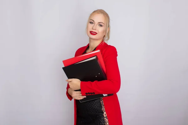 Business woman in jacket holding folders in her hands — ストック写真