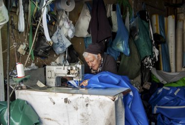Tel Aviv, İsrail - 18 Şubat 2014: Komuta sizde küçük atölyesinde büyük plastik torbalar Ambalaj Sanayi dikiş işgal.