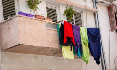 Eski binanın balkonunda renkli çamaşırlar kurutulur. 
