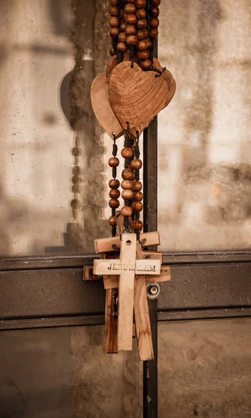 Wood rosary with the heart and the cross with inscription JERUSALEM. Closeup. Aged photo. Sepia.