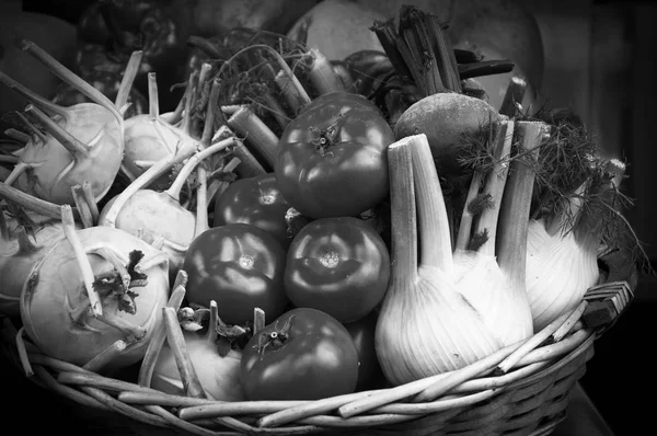 Fresh produce in wicker basket from local farmer's market. Mediterranean diet. Black and white photo.