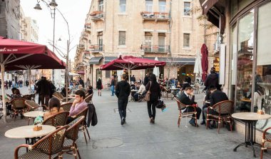 Jerusalem, İsrail - 19 Şubat 2014: Jaffa yol sokak kafe terasında akşam oturan insanlar. Jaffa Road Kudüs'te en uzun ve en eski ana caddelerinden biri olan.