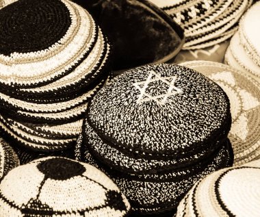 Kipa ile Magen David (davut yıldızı) ve diğer Yarmulkes satışa Jerusalem (İsrail) içinde belgili tanımlık çarşı. Portre. Seçici odak Magen David üst köşesinde. Yahudi arka plan. Sepya.