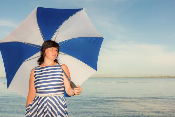 Brunette vrouw met een parasol — Stockfoto