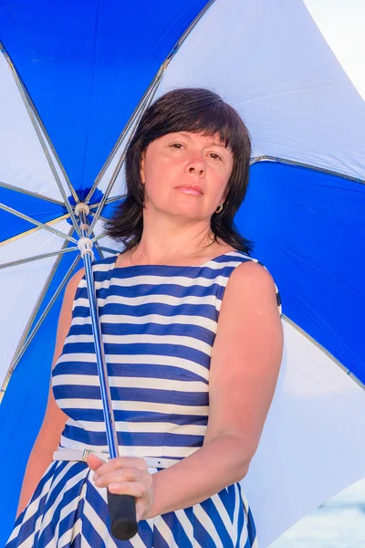 Μελαχρινή γυναίκα με μια ομπρέλα παραλιών — Φωτογραφία Αρχείου