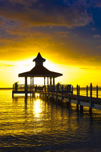 gazebo bridge sea at sunset