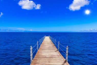 wooden bridge juts out into  of the sea clipart