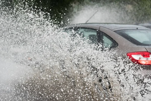 Car rain puddle splashing water — Stock Photo, Image