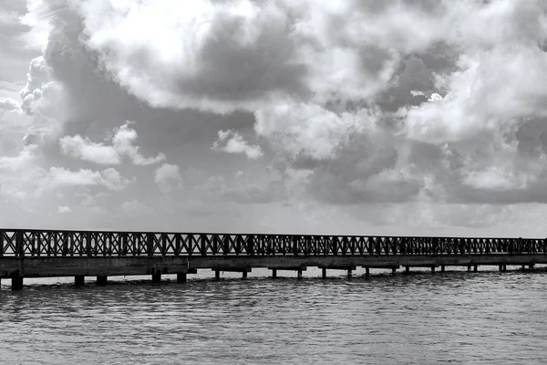 Old wooden pier goes to sea Stock Photo