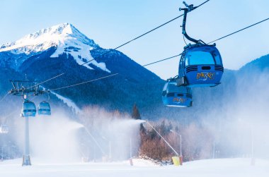Bansko, Bulgaria - February 09, 2020: Winter ski resort Bansko, ski slope, people skiing and mountains view.