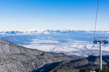 Bansko, Bulgaria - February 10, 2020: Winter ski resort Bansko, ski slope, people skiing and mountains view.