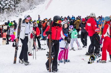 Bansko, Bulgaria - February 14, 2020: Winter ski resort Bansko, ski slope, people skiing and mountains view.