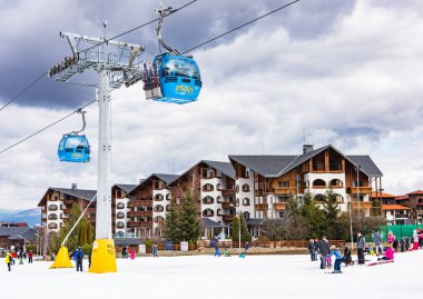 Bansko, Bulgaria - February 14, 2020: Winter ski resort Bansko, ski slope, people skiing and mountains view.