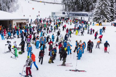Bansko, Bulgaria - February 14, 2020: Winter ski resort Bansko, ski slope, people skiing and mountains view.