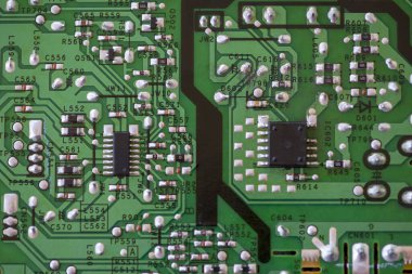 Elektronik bileşenlere yakın çekim. KİS dirençleri, kapasitörler, indüktörler ve entegre devreler.