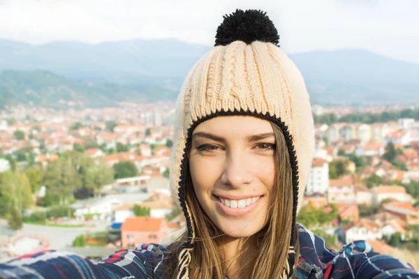 Selfie of young woman in knitted beanie — Stock Photo, Image