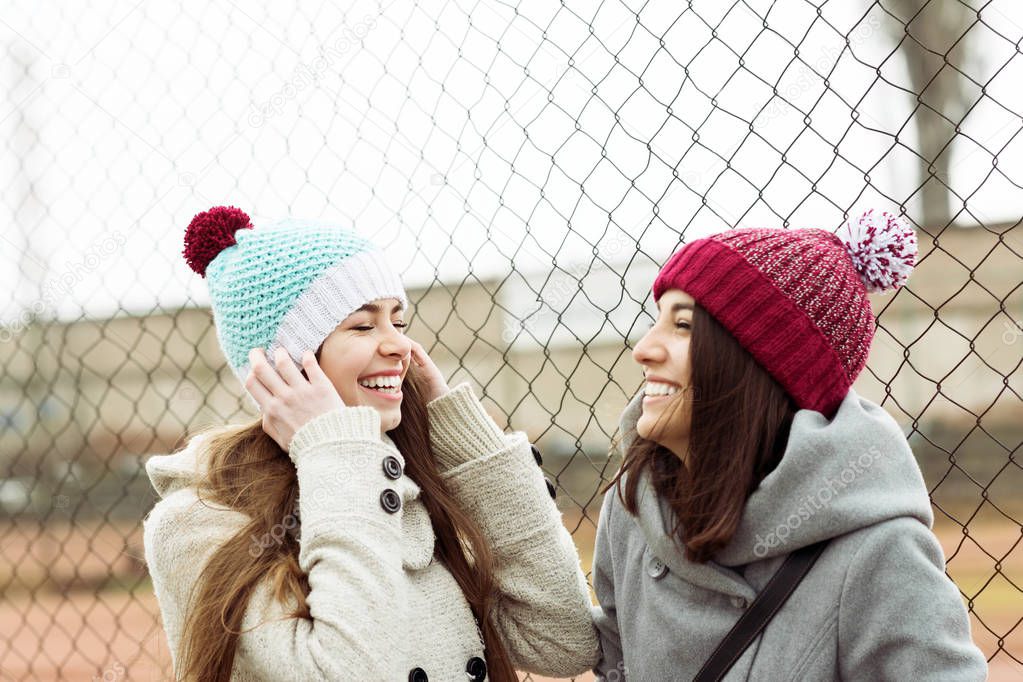 Two cheerful teenage girls laughing