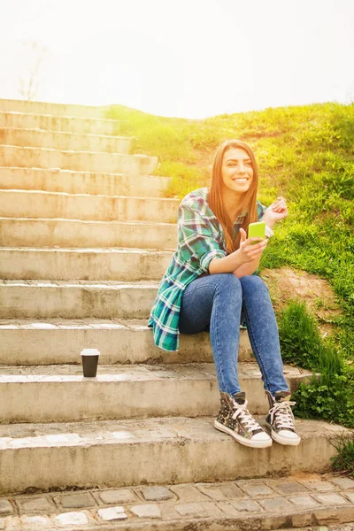 Cheerful teenage girl in park on sunny day — Stock Photo, Image