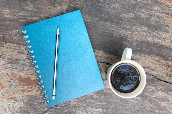 Blue note book with coffee cup — Stock Photo, Image