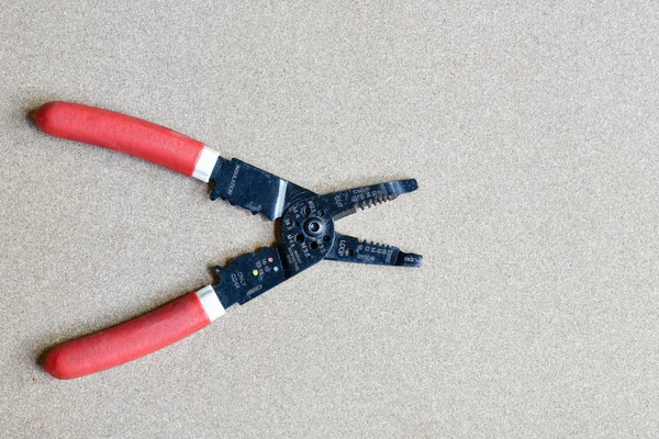 Wire stripping and cutting pliers on wood background