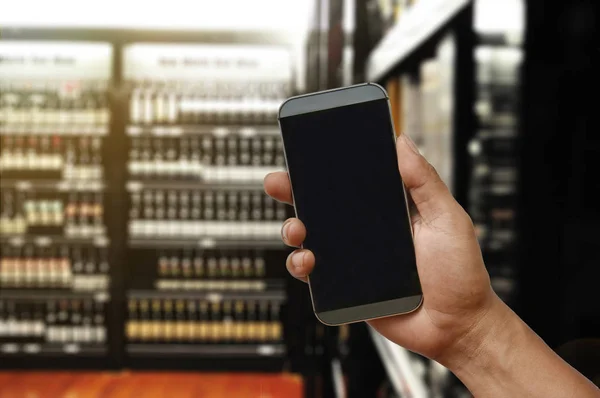a hand holding smartphone on Wine Supermarket store