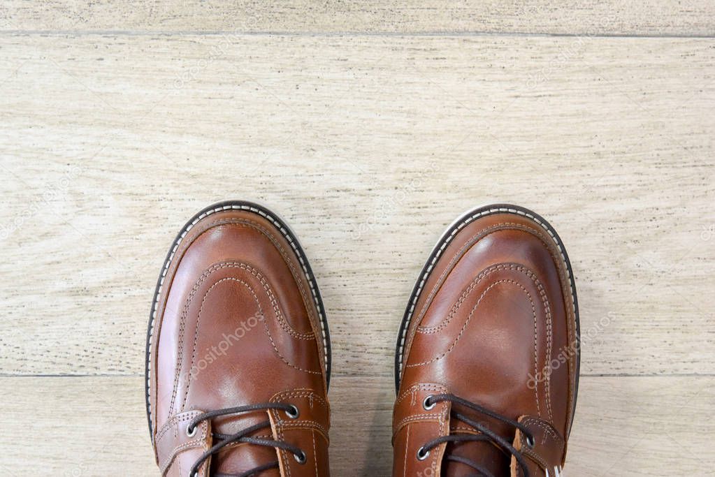 male brown leather shoes on tile floor