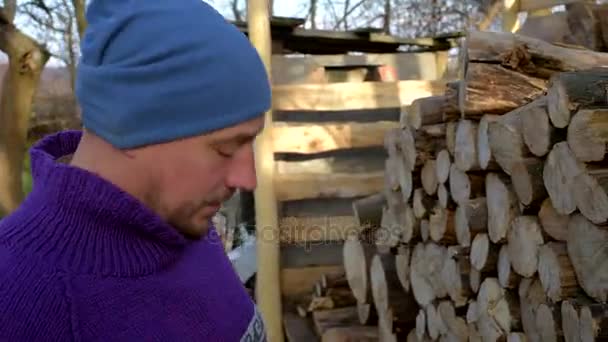 Ein Mann, ein Holzfäller wählt einen Baumstamm zum Schneiden aus. Nahaufnahme. — Stockvideo