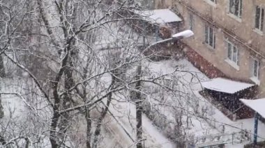 Strong snow falls on the street. Slow motion.