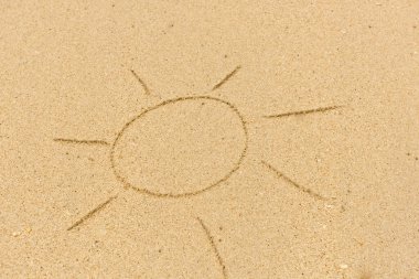 Kum üzerinde çizim yapan güneşin görüntüsü. Sandy arkaplanı.