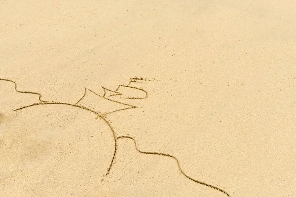 Image of ship  in the sea drawing on sand. Sandy background.