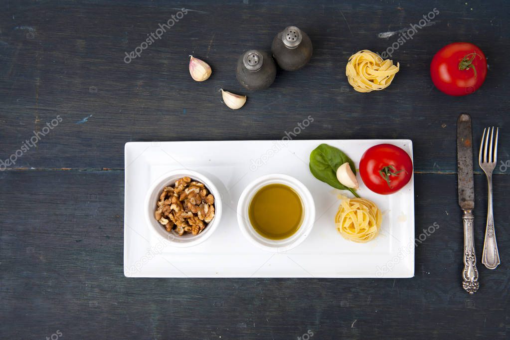 pasta, tomatoes, nuts, pine nuts, olive oil plates