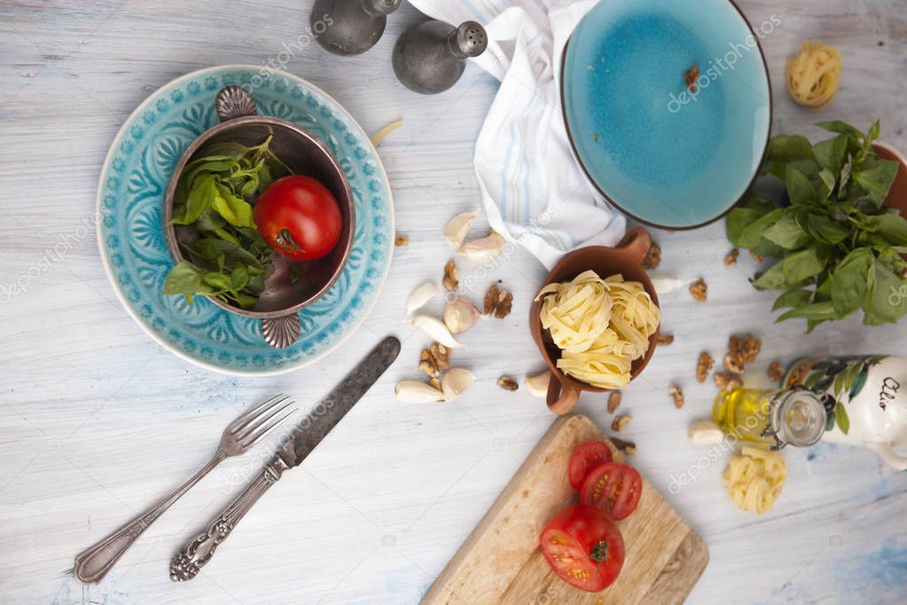 pasta, tomatoes, nuts, pine nuts, olive oil plates