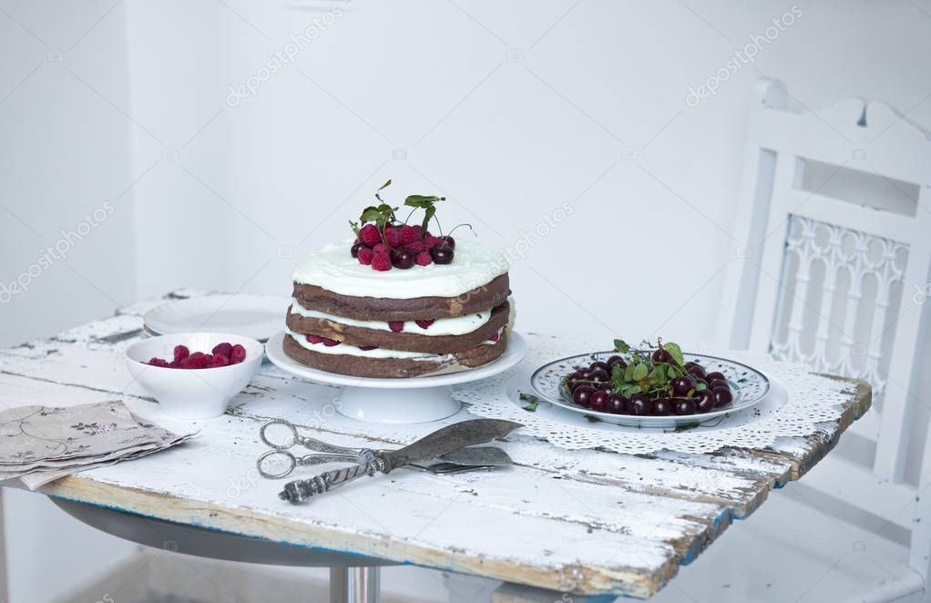 Cocoa Sponge Cake with Whipped Cream and Raspberries, cherries 